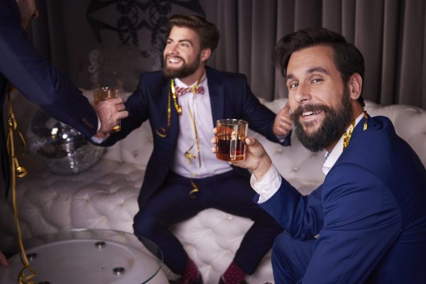 Men drinking whiskey at night club